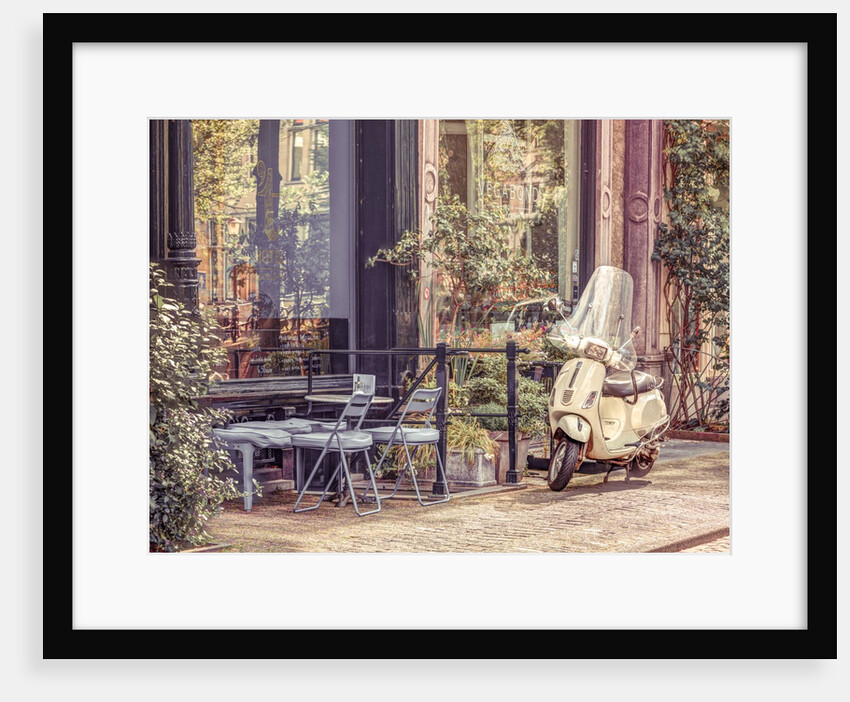 Scooter parked by street cafe by Assaf Frank